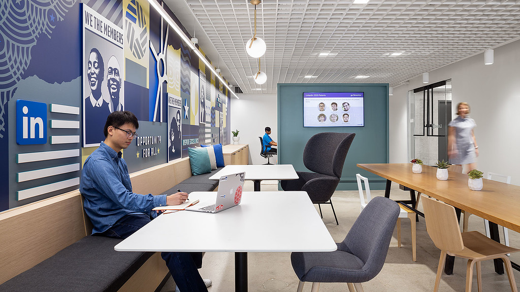A person sitting at a table with a laptop.